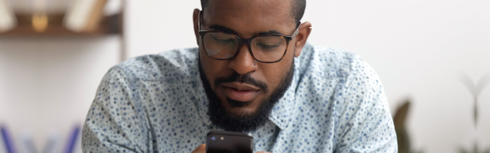 man searching contact on mobile phone